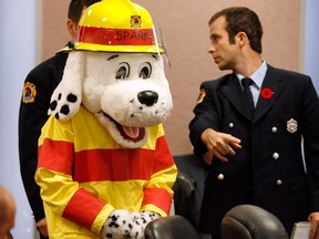 Sparky along with Windsor firefighters John McRae, right and Bob Bailey, behind,  collected gifts from city councillors and staff during Monday's council meeting November 5, 2012.  Sparky's Toy Drive made 3,000 children a little happier during the holiday season last year. (NICK BRANCACCIO/The Windsor Star)