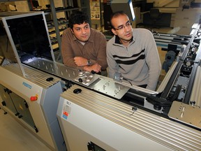 Dr. Tarek Al Geddawy, left, and Dr. Sameh Badrous examine a portion of the state-of-the-art iFactory system at the engineering faculty at the University of Windsor Friday, November 9, 2012.  The system, one of very few in the world,  is a type of "learning factory" for engineering students.  (NICK BRANCACCIO/The Windsor Star)