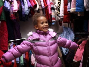 Marissa Spooner, 7, tries on a winter jacket to show her mother, Barb Spooner, at the 28th annual Coats for Kids campaign at the Unemployed Help Centre, Saturday, Nov. 3, 2012.  (DAX MELMER/The Windsor Star)