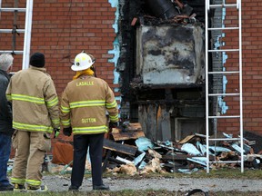 LaSalle firefighters survey the damage caused by a house fire at 2447 Front Rd., in LaSalle, Saturday, Nov. 24, 2012.  No one was injured in the blaze.  (DAX MELMER/The Windsor Star)