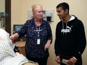Margaret Rice, left, second-year practical nursing co-ordinator, shows Jas Bhatia, 17, a senior at Riverside secondary school, a simulation room in the Centre for Applied Health Sciences at an open house at St. Clair College, Saturday, Nov. 24, 2012.  (DAX MELMER/The Windsor Star)