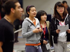 Univerisity of Windsor international students Maybelle Wong, left, Sabrina Luo and Connie Yu, all from China, support their classmates during a day of sporting activities at the St. Denis Centre,  November 12, 2010. (NICK BRANCACCIO/ The Windsor Star)