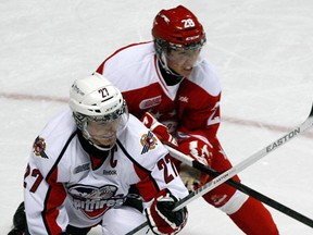 Spitfires captain Saverio Posa, left, battlesthe Soo's Sergey Tolchinsky at the WFCU Centre. (NICK BRANCACCIO/The Windsor Star)