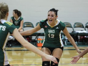 St. Clair's Samantha Bueckert, right, celebrates with her teammates in an OCAA volleyball game against Redeemer College Saturday at St. Clair College. (DAX MELMER/The Windsor Star)