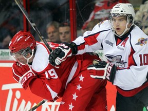 Spitfires defenceman Patrick Sieloff, right, checks Jared McCann of the Greyhounds at the WFCU Centre. (NICK BRANCACCIO/The Windsor Star)