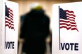 A U.S. citizen votes in the presidential election at Carleton Middle School November 6, 2012 in Sterling Heights, Michigan. Recent polls show that U.S. President Barack Obama and Republican presidential candidate Mitt Romney are in a tight race. (Photo by Bill Pugliano/Getty Images)