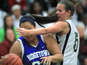 Lajeunesse's Kathryn McFadden, right, battles with Ridgetown's Cheyenne Hopkins is SWOSSAA girls basketball Wednesday. (DAN JANISSE/The Windsor Star)