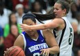 Lajeunesse's Kathryn McFadden, right, battles with Ridgetown's Cheyenne Hopkins is SWOSSAA girls basketball Wednesday. (DAN JANISSE/The Windsor Star)