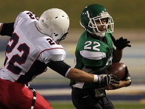 Herman's Jaydon Gauthier, right, tries to turn the corner on Matt Mancina of Holy Names in the Newman Conference championship game at Alumni Field. (NICK BRANCACCIO/The Windsor Star)