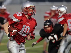 Brennan's Kellen Leclair, left, heads for the end zone on a 15-yard run against Essex in playoff football action at Alumni Field. (NICK BRANCACCIO/The Windsor Star)