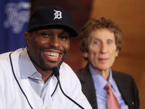 Tigers outfielder Torii Hunter, left, is introduced to the media with owner Mike Ilitch sitting in the background. (AP photo/Carlos Osorio)