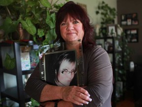 Sally Boismier is pictured with a portrait of her late daughter, Samantha Boismier-Couvillio, at her home, Sunday, Nov. 18, 2012.  Sally has been attending a bereavement program at the Windsor/Essex County branch of the Canadian Mental Health Association after her daughter Samantha passed away unexpectedly on April 3, 2011, at the age of 24.  (DAX MELMER/The Windsor Star)
