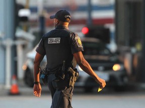 File photo of a Canada Border Services Agency officer near secondary inspection at the Windsor-Detroit Tunnel in Windsor, Ont. (Windsor Star files)