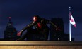 The Crimson Canuck is shown on a roof overlooking Windsor on Monday, November 12, 2012. Crimson Canuck, who dresses as a masked superhero and does not reveal his true identity, walks the streets of Windsor one or two nights a week, handing out socks and gloves to the needy.                  (TYLER BROWNBRIDGE / The Windsor Star)