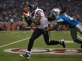 Houston WR, Andre Johnson, left, makes a reception for 43 yards while being defended by Detroit's Louis Delmas in the 2nd quarter of NFL action between the Detroit Lions and the Houston Texans at Ford Field, Thursday, Nov. 22, 2012.  Houston defeated Detroit 34-31 in over time.  (DAX MELMER/The Windsor Star)