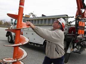 Enwin Utilities Ltd. worker Duane Matthews installs an auger on a radial boom line truck at Enwin's Rhodes Drive facility Monday November 5, 2012. A team of six Enwin workers are heading to neighbourhoods affected by Hurricane Sandy. (NICK BRANCACCIO/The Windsor Star)