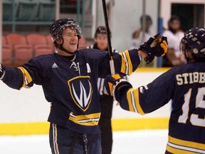 In this file photo,  University of Windsor Lancers Drew Palmer, left, and Evan Stibbard celebrate Stibbard's goal against Laurier Golden Hawks in OUA hockey action from Windsor Arena October 26, 2012.  (NICK BRANCACCIO/The Windsor Star)