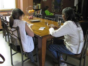 In this file photo, a pair of residents at the Well-Come Centre in Windsor, Ont. for homeless women play rummy. (Windsor Star files)