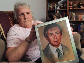 Joyce Dundas holds a painting of her late husband Monday, Nov. 12, 2012, at her Wheatley, Ont. home. He was killed in a car accident 24 years ago. She is still trying to get settlement money from an insurance company.  (DAN JANISSE/The Windsor Star)