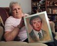 Joyce Dundas holds a painting of her late husband Monday, Nov. 12, 2012, at her Wheatley, Ont. home. He was killed in a car accident 24 years ago. She is still trying to get settlement money from an insurance company.  (DAN JANISSE/The Windsor Star)