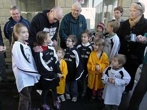 In this file photo, Frank Spry, left, and Jerry Slavik, centre, talk with a group of kids during a fundraiser announcement for the Knobby's Kids Hockey program in Windsor, Ont. on Wednesday, Nov. 21, 2012. The organization was presented with a cheque for $5,000 by the St. Clair College Alumni Association.                  (TYLER BROWNBRIDGE / The Windsor Star)