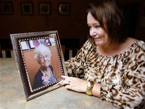 Luanne Ives with a portrait of her late mother Marie Deneau Thursday October 25, 2012.  (NICK BRANCACCIO/The Windsor Star)