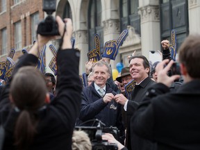 University of Windsor president Alan Wildeman, left,  accepts the keys to the old Windsor Star building from publisher Marty Beneteau during a ceremony at Pitt Street and Ferry Street in Windsor, Ontario on November 30, 2012.  (JASON KRYK/ The Windsor Star)