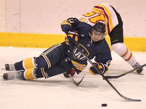 Windsor's Spencer Pommells, bottom, is checked by Guelph's Philip Teri at Windsor Arena. (DAN JANISSE/The Windsor Star)