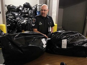 Sgt. Matthew D'Asti leads a press conference outside of an evidence locker at  Windsor Police Headquarters in Windsor, Ont. on Wednesday, November 21, 2012. Police displayed the 491 pounds of marijuana they seized in Amherstburg last week.                  (TYLER BROWNBRIDGE / The Windsor Star)