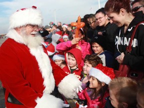 Santa greets a large crowd of children and their parents after he arrived at Devonshire Mall in Windsor, Ont., on a helicopter, Sunday, Nov. 18, 2012.  (DAX MELMER/The Windsor Star)