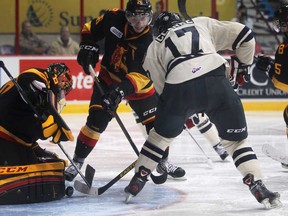 Windsor's Michael Clarke, right, fights for the puck with Belleville's Stephen Silas in front of the Belleville goaltender, Malcolm Subban, left, during OHL action between the Windsor Spitfires and the Belleville Bulls at the WFCU Centre, Sunday, Nov. 4, 2012.  (DAX MELMER/The Windsor Star)