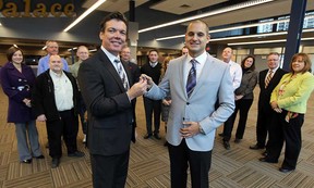 David Mady hands over the keys to the new offices of The Windsor Star to publisher Marty Beneteau, left, at the new home of The Star in the former Palace Theatre on Thursday, November 1, 2012.               (TYLER BROWNBRIDGE / The Windsor Star)