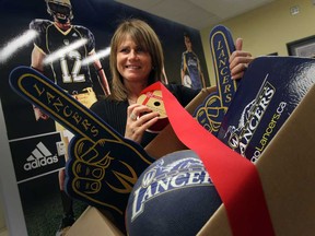 Shari Turcotte, the University of Windsor athletics department administrative assistant, prepares a gift box during  preparations for the @WindsorLancers  Holiday Adopt a Family Campaign.  The U of W  has been adopting a family for Christmas  for the past 21 years. (JASON KRYK/ The Windsor Star)