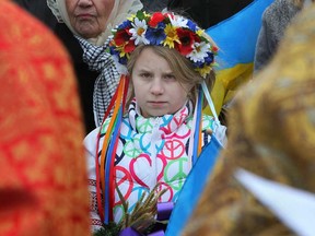 A young girl attends a Holodomor observance at the Holodomor memorial site at Jackson Park in Windsor, Ont., Sunday, Nov. 25, 2012.  Local Ukrainians are observing the 80th anniversary of the mass starvation of Ukrainians under Joseph Stalin in the 1930's.  (DAX MELMER/The Windsor Star)