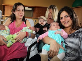 Day-old twins Everett, left, and Andrew Parish and their mother Sharon Parish are welcomed by new moms Shea Snoei and son, Kai, and Michelle Boutros, right, with daughter Karina, at Leamington District Memorial Hospital,  November 21, 2012. (NICK BRANCACCIO/The Windsor Star)