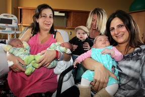 Day-old twins Everett, left, and Andrew Parish and their mother Sharon Parish are welcomed by new moms Shea Snoei and son, Kai, and Michelle Boutros, right, with daughter Karina, at Leamington District Memorial Hospital,  November 21, 2012. (NICK BRANCACCIO/The Windsor Star)