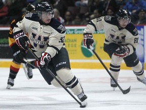 Windsor's Emerson Clark, left, brings the puck up the ice against the Belleville Bulls at the WFCU Centre. (DAX MELMER/The Windsor Star)