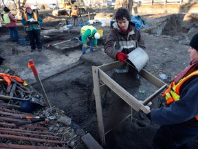 Workers with Fisher Archaeological Consulting sift through cubic metres of dirt on the shore of the Puce River at the Puce River bridge during an archaeological excavation prior to roadwork on County Road 22 November 27, 2012. The excavation and related search for artifacts will continue for another two weeks. (NICK BRANCACCIO/The Windsor Star)