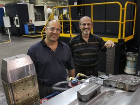 Euclide Cecchin, right, and his son Dave Cecchin pose July 28, 2010, at the Omega Tool Corp. (DAN JANISSE/The Windsor Star)
