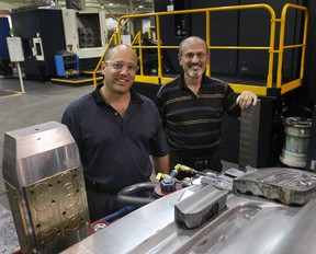 Euclide Cecchin, right, and his son Dave Cecchin pose July 28, 2010, at the Omega Tool Corp. (DAN JANISSE/The Windsor Star)