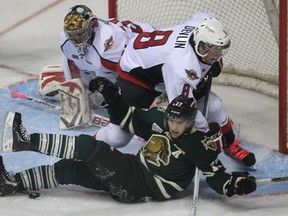 London's Seth Griffith, front, is checked by Windsor's Brandon Devlin in front of goalie Jaroslav Pavelka Thursday at the WFCU Centre. (DAN JANISSE/The Windsor Star)