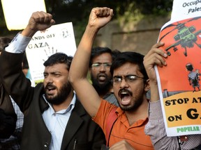 Indian students hold placards as they shout anti-Israel slogans during a protest outside the Israeli embassy in New Delhi on November 19, 2012.  Dozens of students took part in the protest demanding that the Indian government snap all ties with the government of Israel including all the defence deals in the pipeline, and urge the Israeli forces to stop air strikes in Gaza.SAJJAD HUSSAIN/AFP/Getty Images