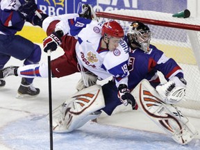 Team Russia's Alexander Khokhlachev, left, collides with with Team Slovokia goalie Juraj Simboch at the 2012 world juniors at the Scotiabank Saddledome in Calgary. (Leah Hennel/Calgary Herald)