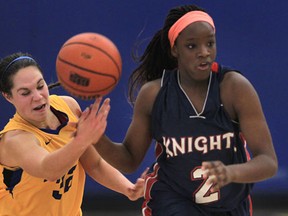 St. Anne's Alana Gyemi, left, battles Ayoleka Sodade of Holy Names in the girls basketball final in Lakeshore Wednesday. (DAN JANISSE/The Windsor Star)