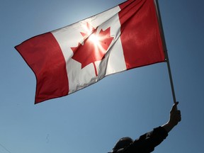 In this file photo, a union supporter waves a Canadian flag in front of the Caesars Windsor Casino Friday, May 11, 2012, in Windsor, Ont. (DAN JANISSE/The Windsor Star)