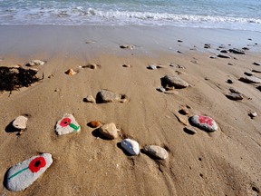 Pebbles with poppies painted on are seen on the beach of Saint-Aubin-sur-Mer on June 5, 2009 during a ceremony in memory of Canadian troops who landed in 1944 at the Nan Red point on Saint-Aubin beach. Each poppy painted by students represents a soldier killed here during World War II. Preparations are underway for the upcoming D-Day celebrations to mark the 65th anniversary of the June 6, 1944 allied landings in France, then occupied by Nazi Germany. US President Barack Obama is to lead commemorations attended by thousands of Americans on June 6 at the ceremony above Omaha Beach, where more than 9,000 US troops fought and died in June 1944.    MYCHELE DANIAU/AFP/Getty Images