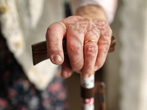 File photo of an  81-year old senior holding on to her floral patterned walking stick at home on February 17, 2010 in England (Postmedia News files).