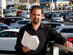 AutoMaxx general manager Mickey Cleroux checks his inventory list of pre-owned vehicles Nov. 8, 2012. (NICK BRANCACCIO/The Windsor Star)