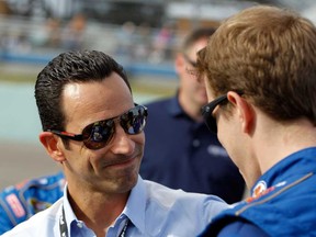 Indy Racing League driver Helio Castroneves, left, talks with NASCAR's Brad Keselowski Sunday in Homestead, Fla. Catroneves said Tuesday he likes the track changes made for the Detroit Belle Isle Grand Prix.  (Tom Pennington/Getty Images)