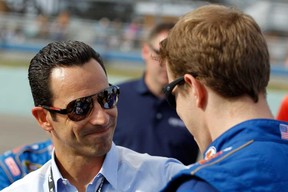 Indy Racing League driver Helio Castroneves, left, talks with NASCAR's Brad Keselowski Sunday in Homestead, Fla. Catroneves said Tuesday he likes the track changes made for the Detroit Belle Isle Grand Prix.  (Tom Pennington/Getty Images)